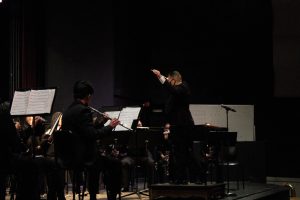 Jared Cassedy conducts Wind Ensemble at the winter concert. Photo by Angie Xu