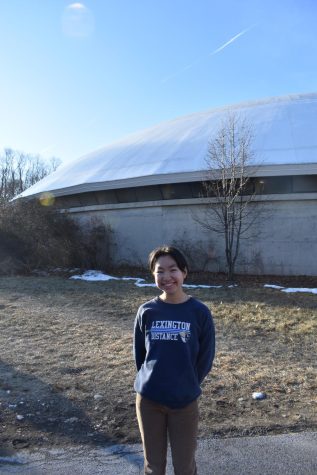 Clara Fu stands in front of the Lexington Fieldhouse. Photo by Michael Gordon