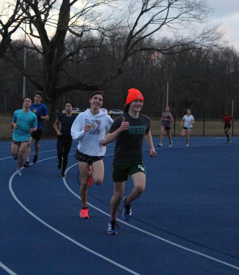 Mid and long distance track athletes doing a workout outside. Photo by Angie Xu